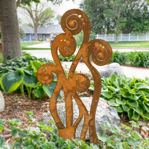 Fern metal sculpture in garden bed