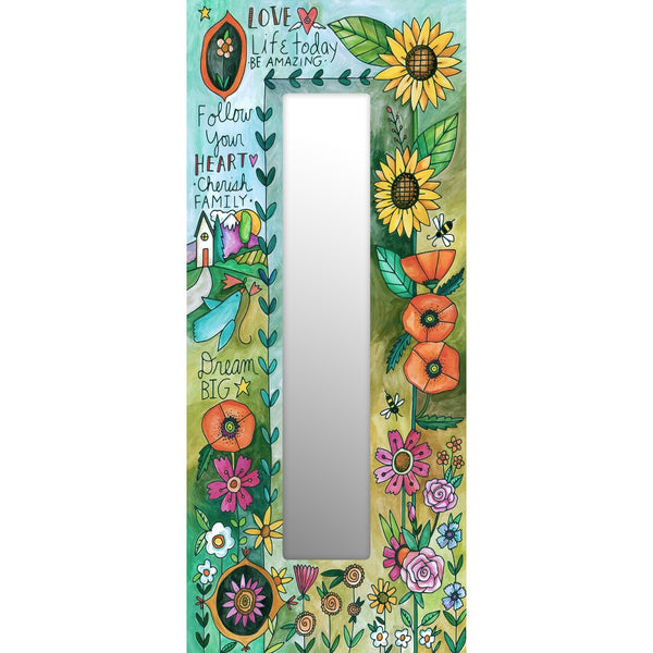A rectangular mirror with a colorful floral and garden motif border, featuring motifs of sunflowers and other flowers, with inspirational words written along the edge.