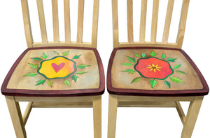 Dining chairs with heart and flower surrounded by leaves 