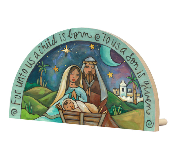 Decorative nativity scene with Mary, Joseph, and baby Jesus against a starry night sky.