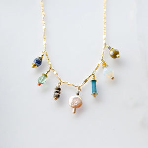 This handmade necklace features a vibrant assortment of beads, including natural gemstones