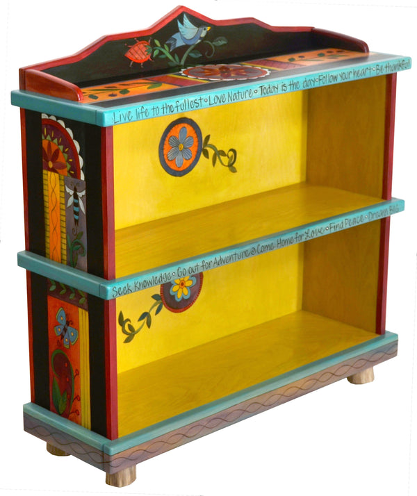 Short Bookcase –  Colorful folk art book case painted in rich hues and designed with floral motifs