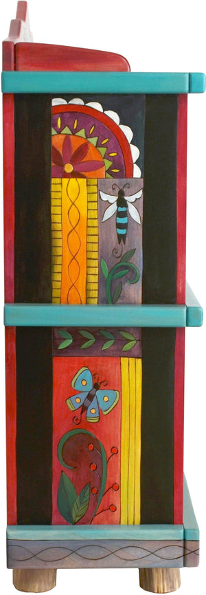 Short Bookcase –  Colorful folk art book case painted in rich hues and designed with floral motifs 