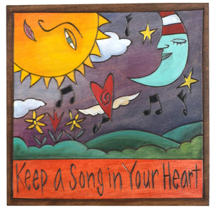 Sticks handmade wall plaque with "Keep a Song in Your Heart" quote and sun and moon motif