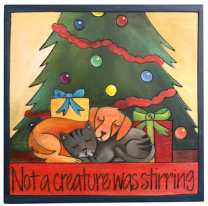 Sticks handmade wall plaque with "Not a creature was stirring" quote and a cat and a dog sleeping together under the Christmas tree with presents