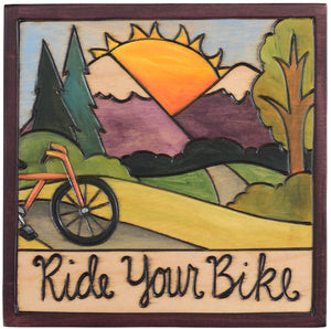 Sticks handmade wall plaque with "Ride your bike" quote and mountain landscape
