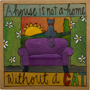 Sticks handmade wall plaque with "A house is not a home without a cat" quote and cat sitting by the window living room scene