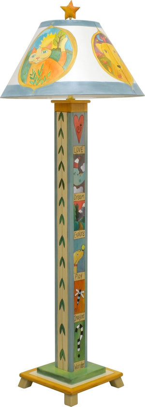Seasonal critter medallions fill this lamp shade and the base features folky stacked boxed icons