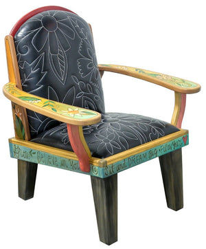 Friedrich's Chair and Matching Ottoman – Black and white floral leather seat and patchwork ottoman design, with coordinating colorful patchwork design filling the back of the oversized chair side view