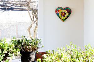 "Loving Time" Heart Clock – A landscape design fills this heart shaped clock displayed in a home's sunroom