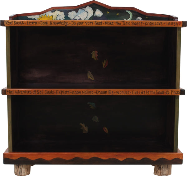 Short Bookcase –  "Go Out for Adventure/Come Home for Love" bookcase with sun and moon over snow-capped mountains motif