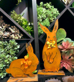Henry Rabbit Sculpture – Dapper standing rabbit sculpture with a bowtie to celebrate spring season and Easter displayed in front of greenery