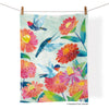 Colorful towel with hummingbirds and flowers hanging on a line.