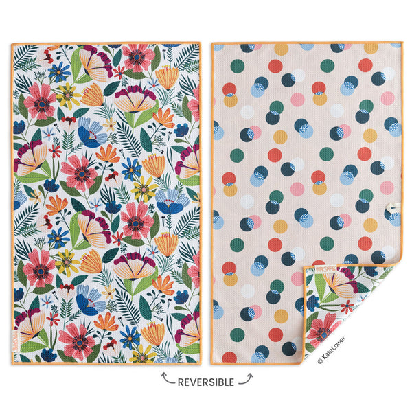 Two reversible dish cloths with floral and polka dot patterns on a white background.