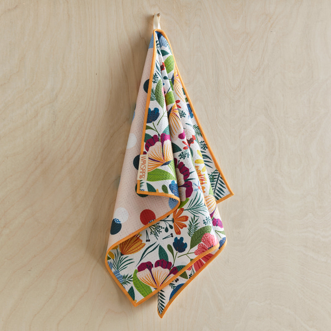 Colorful floral-patterned towel hanging on a wooden surface