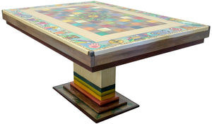 A colorful, traditional patchwork design with inspiring icons surrounding a handcrafted dining table