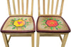 Dining chairs with heart and flower surrounded by leaves 