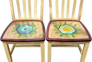 Dining chairs with sun and moon surrounded by leaves