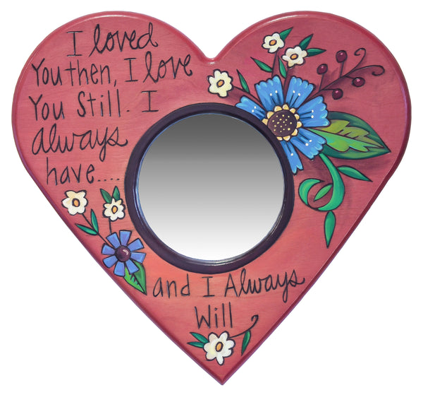 Heart-shaped mirror with floral designs and text on a white background