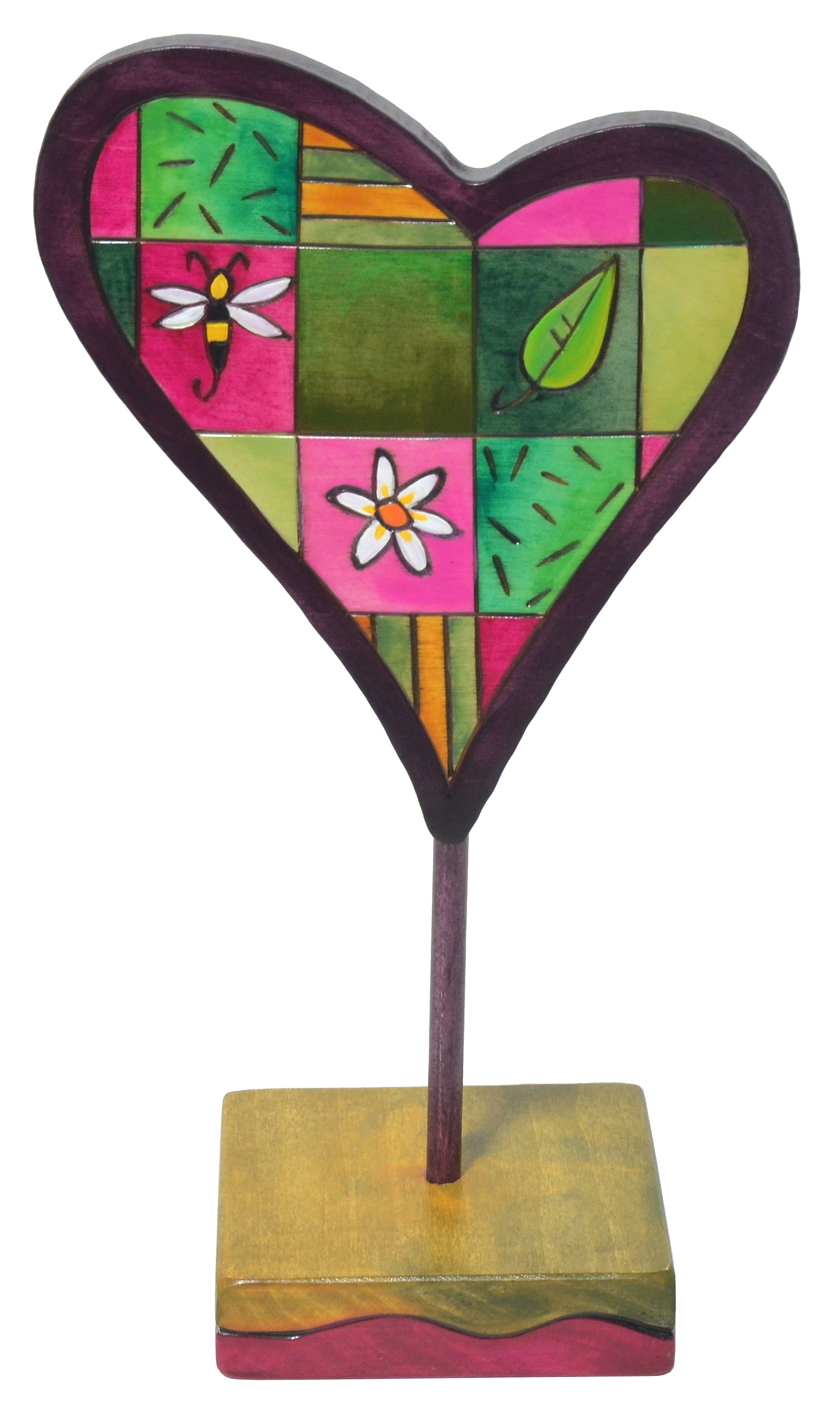 Colorful heart-shaped sculpture with floral designs on a white background