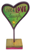 Decorative heart-shaped sculpture with 'Live Love Laugh' text on a stand.