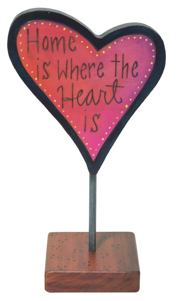 Heart-shaped sculpture with 'Home is where the heart is' text on a white background