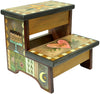Handmade wooden step stool with artistic designs and text on a white background