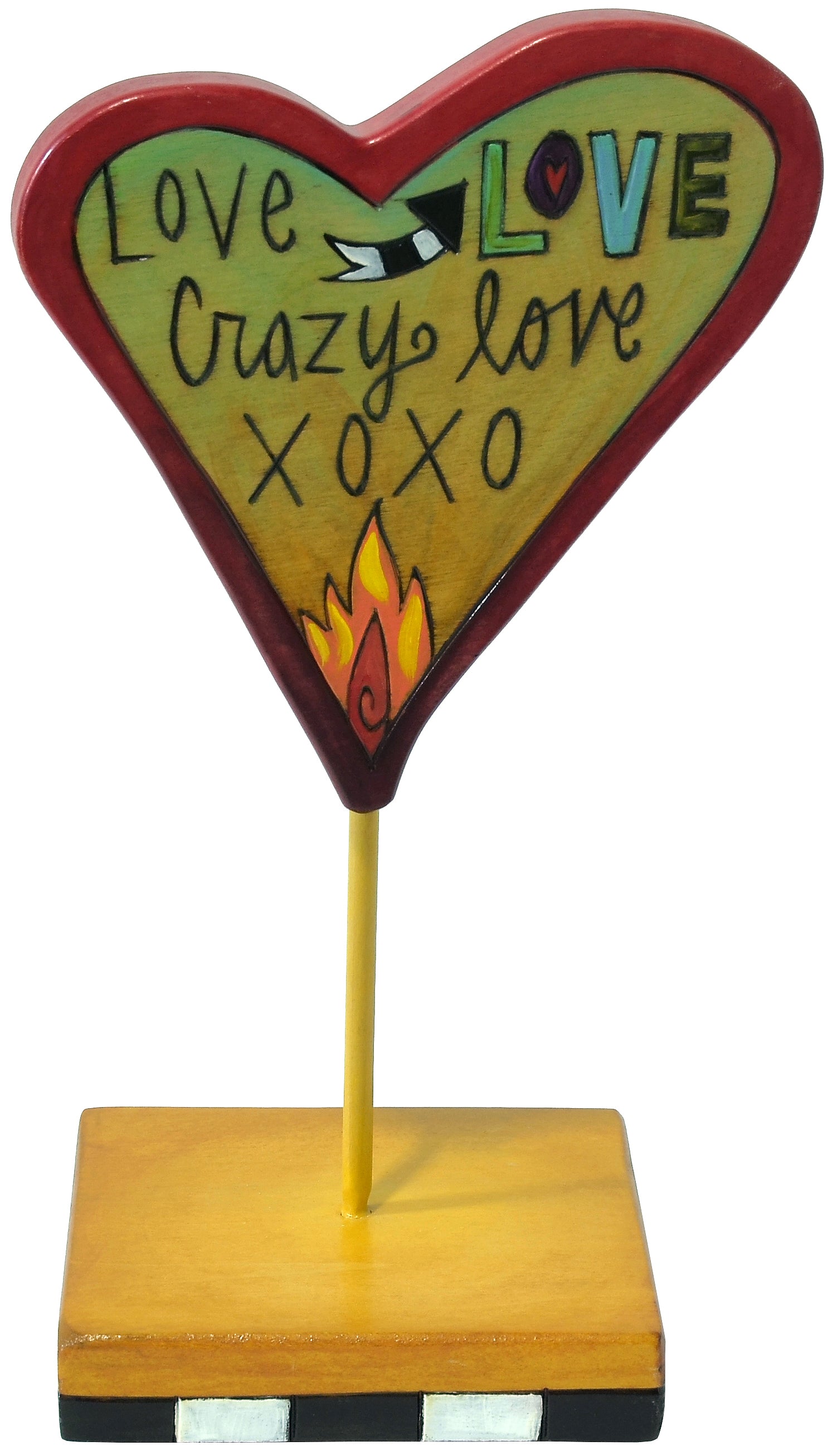Heart-shaped sculpture with 'Love Crazy Love XOXO' text on a stand