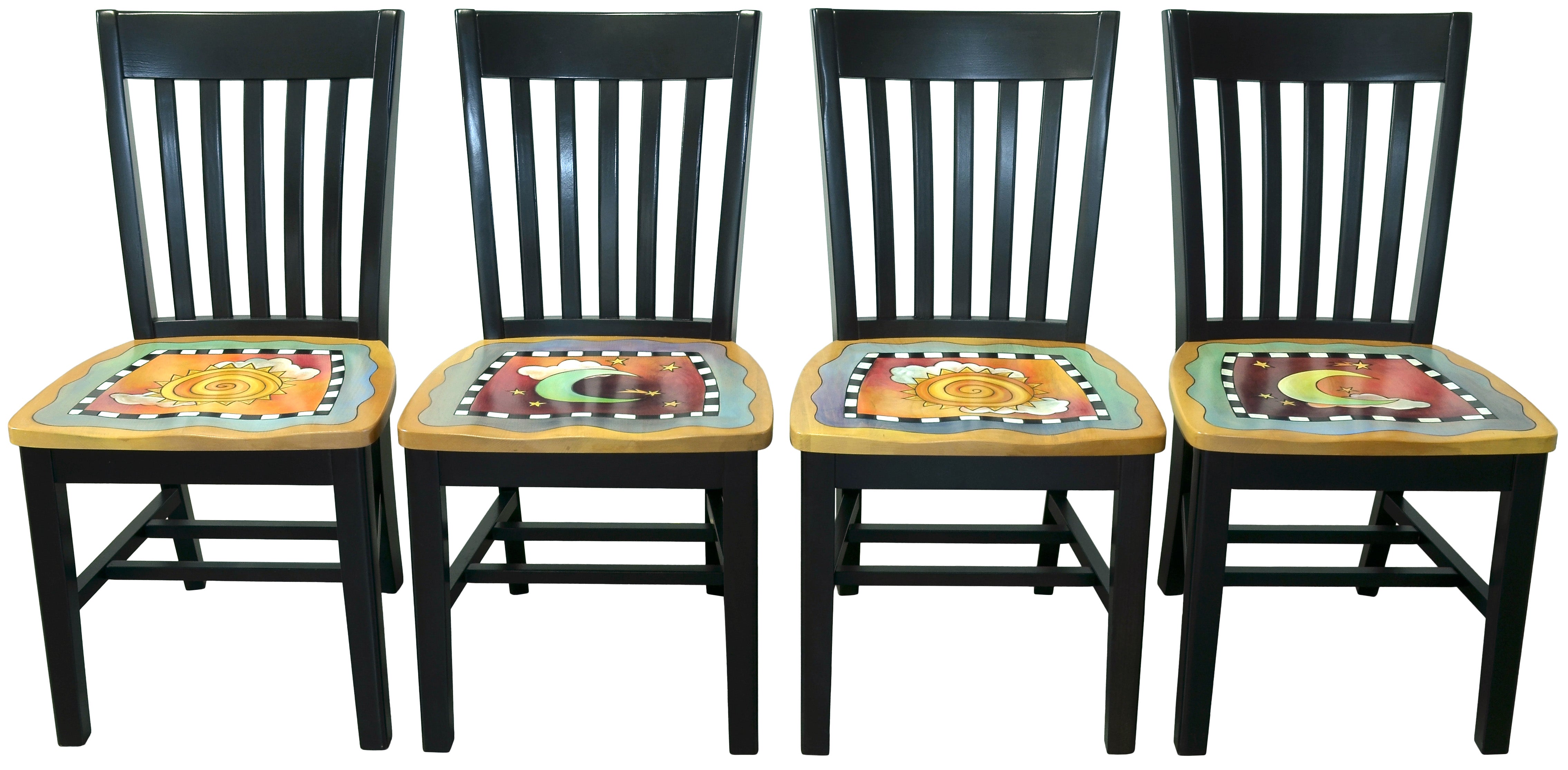 Four black wooden chairs with sun and moon artwork on the seats, against a white background.
