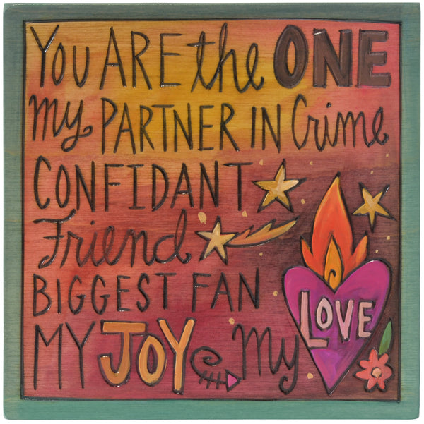 Wooden plaque with romantic text and heart design on a green border