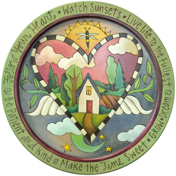 Green round tray decorated with a celestial heart design and a home landscape scene in the center.