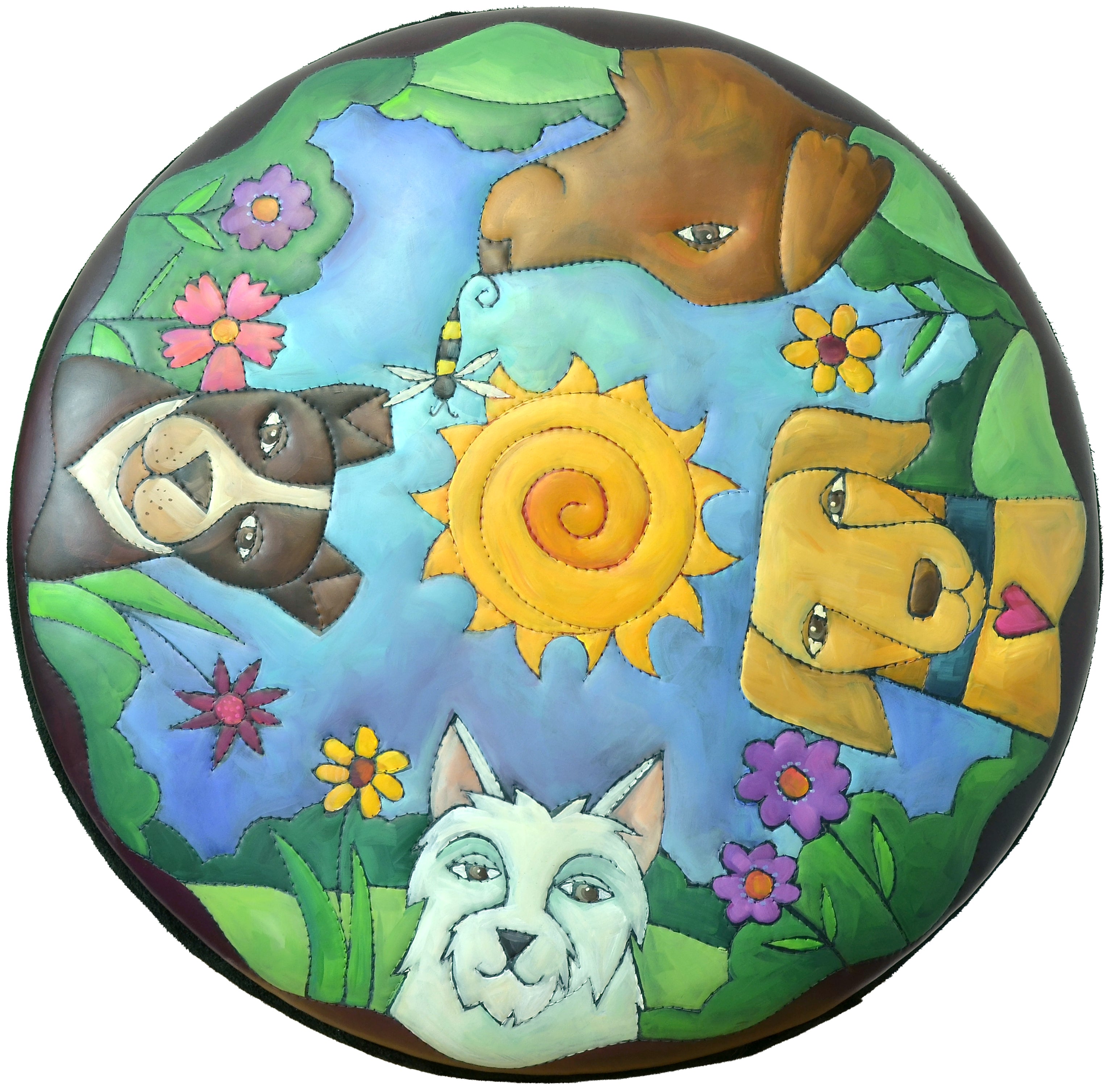 Top view of hand painted circle leather ottoman featuring four dogs heads with a nature motif