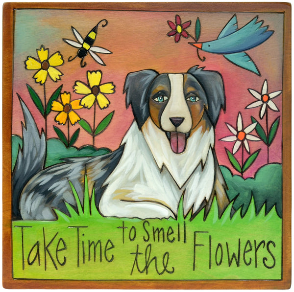 Decorative plaque with an Australian Shepherd dog illustration and floral elements, featuring the text 'Take Time to Smell the Flowers'.