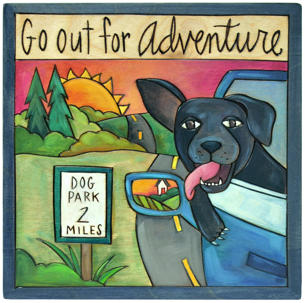 Decorative wooden plaque with a black dog in a car, 'Go out for Adventure' text, and a dog park sign.