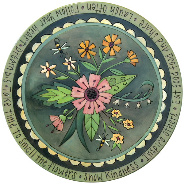 Decorative lazy susan with floral design and inspirational text on a white background