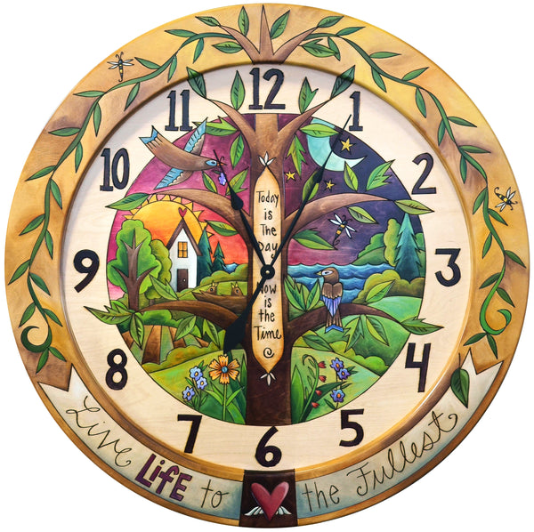 Colorful painted clock featuring a tree of life and day to night landscape scene