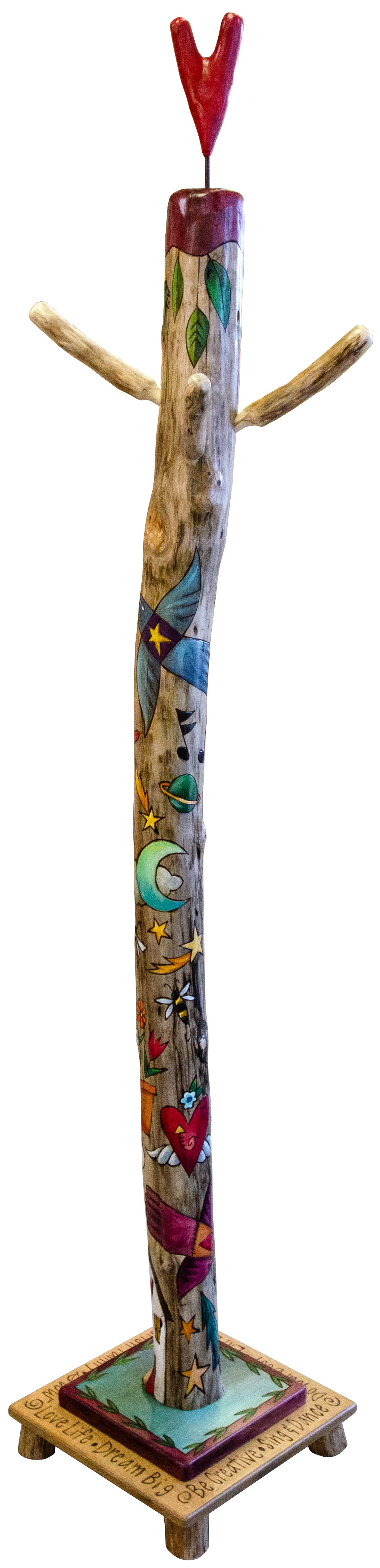 Decorative log coat tree with colorful designs on a stand