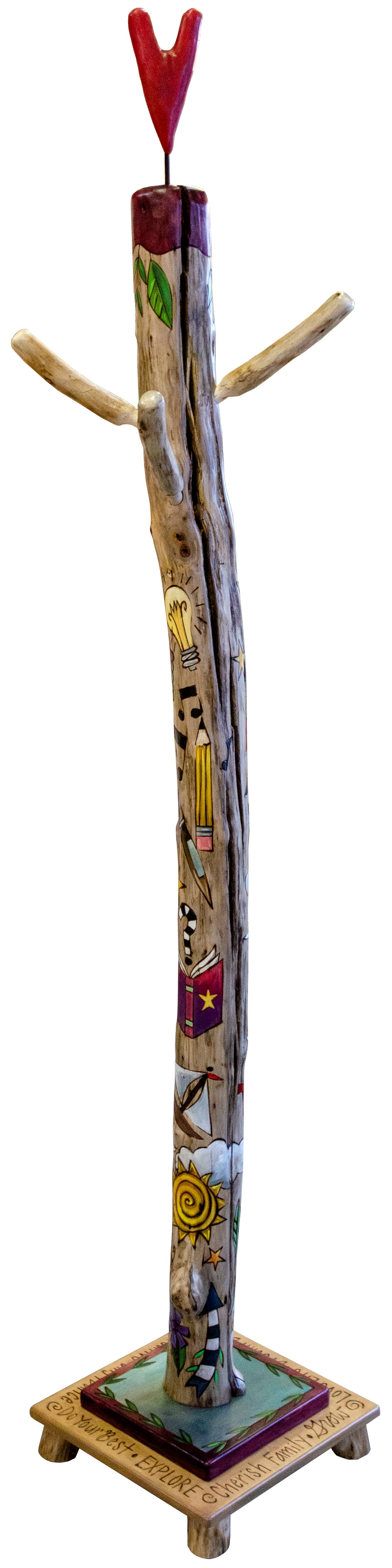 Decorative log coat tree with colorful designs on a stand