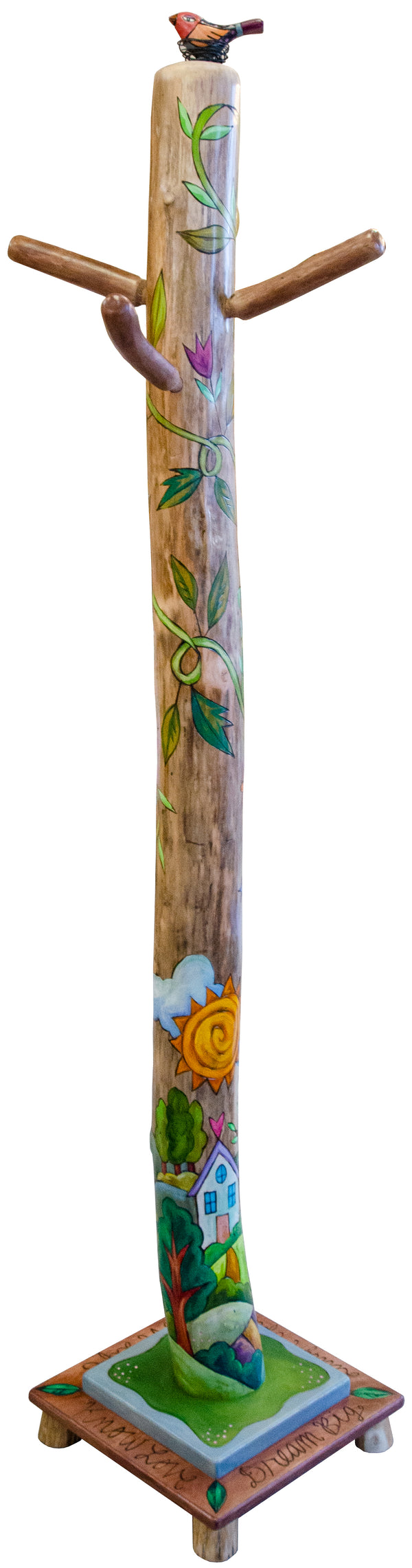 Decorative hand-painted log coat tree with colorful designs and a bird figure on top against a white background