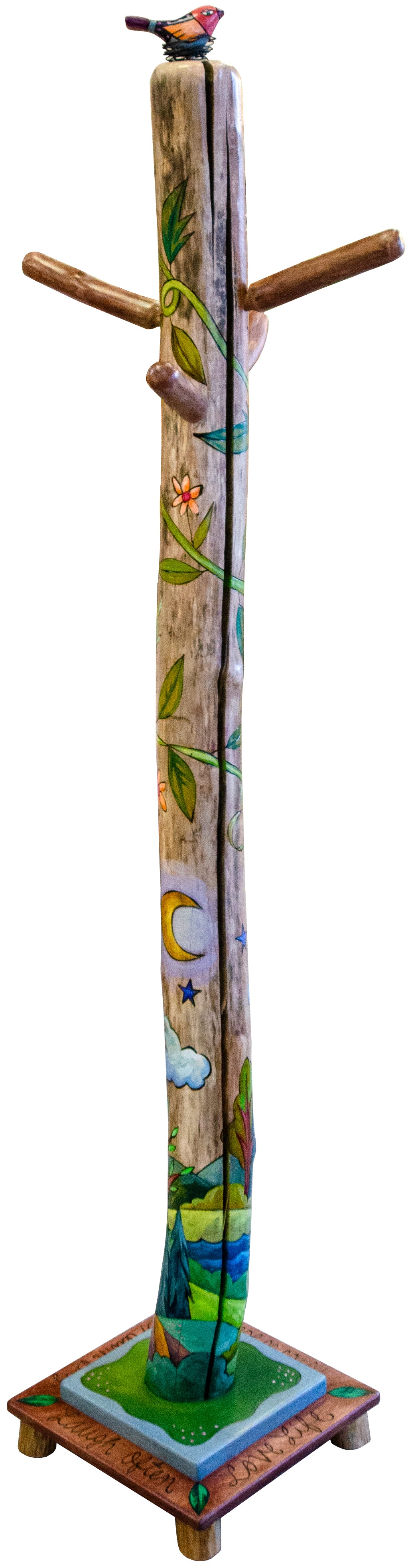 Drift wood log coat tree with colorful painted design on a white background