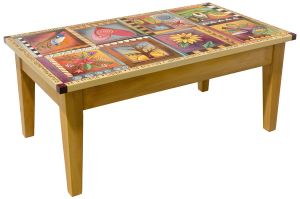 A wooden coffee table with a colorful hand-painted mosaic design on the top surface, set against a plain white background.