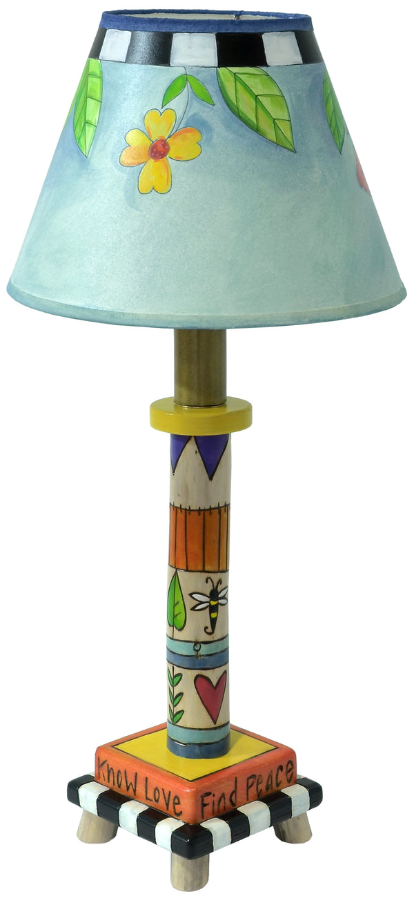 Colorful lamp with a decorated base and lampshade on a white background