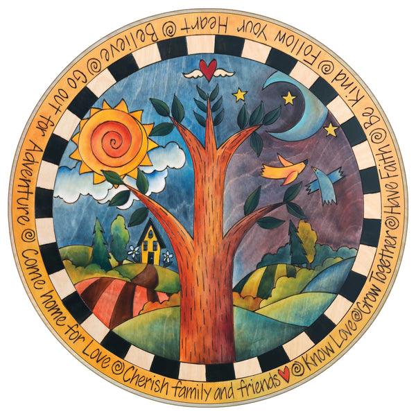 Decorative lazy susan with a tree, sun, moon, and birds in a scenic design with motivational phrases.