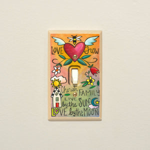 Heart icon surrounded by icons and positive phrases on a unique wood switch cover