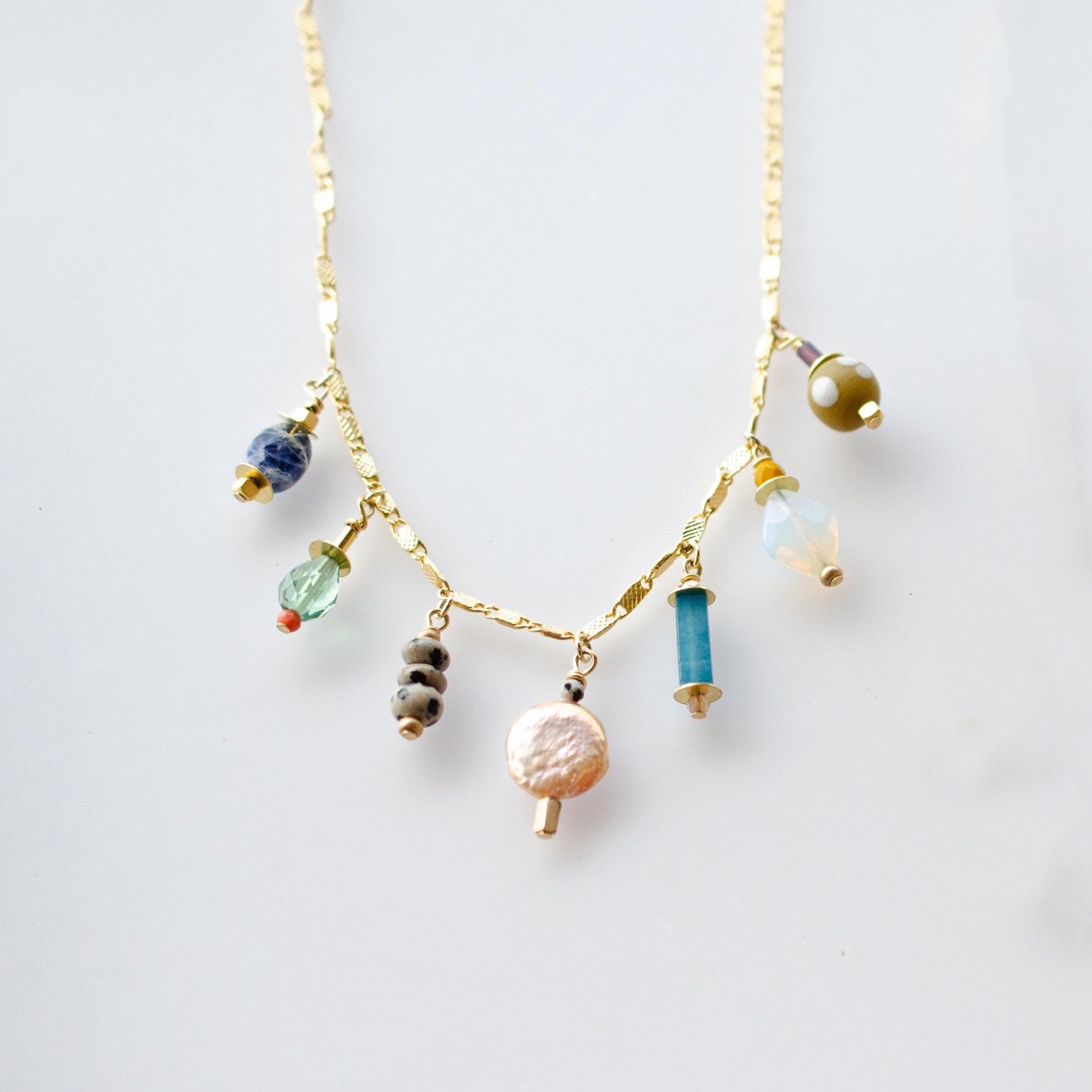 This handmade necklace features a vibrant assortment of beads, including natural gemstones