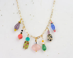 This handmade necklace features a vibrant assortment of beads, including natural gemstones