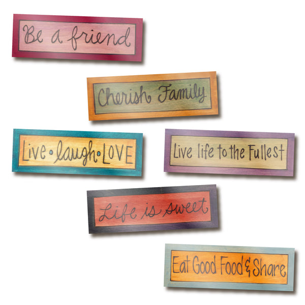 Set of colorful acrylic magnets with motivational phrases on a white background