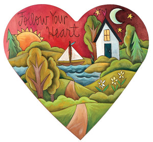Heart-shaped wall art with a beautiful outdoor landscape and a loving home
