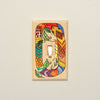 A colorful folk art snake printed on a wood light switch cover! 