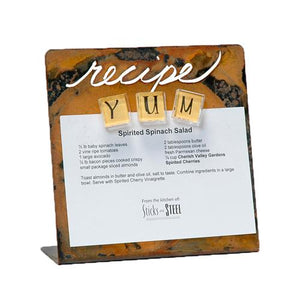 "Recipe" is laser cut through metal on the side of this magnetic recipe holder which keeps recipes up of the counter and away from spills and makes a great house warming or wedding gift